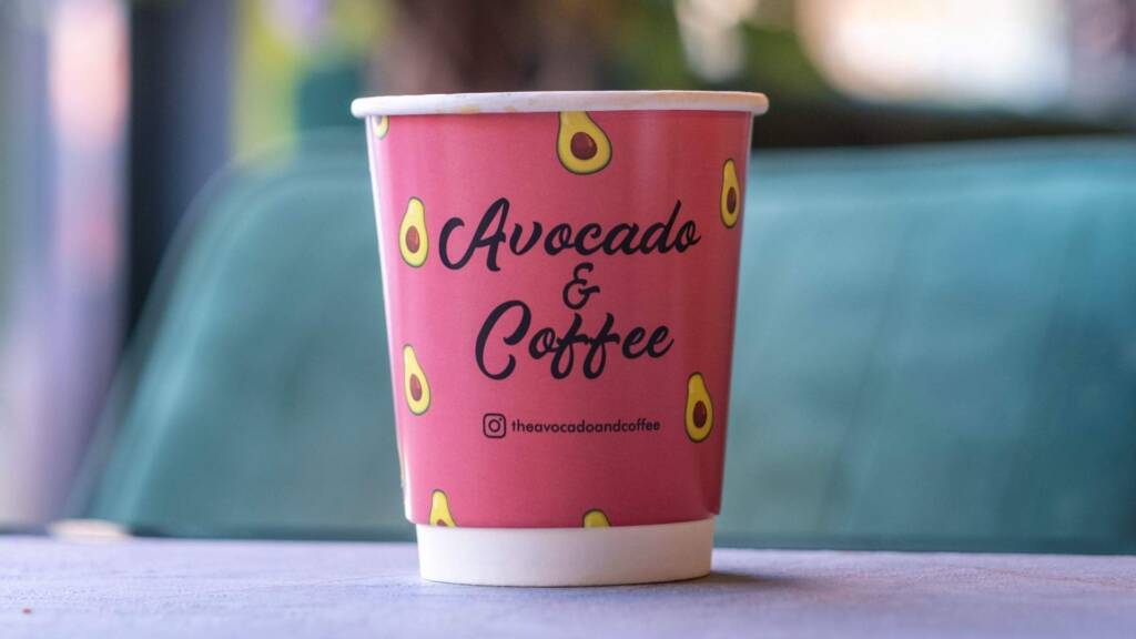 Avocado & Coffee's custom cup design, representing their commitment to organic coffee and sustainable practices.